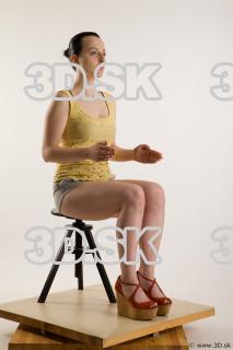 Sitting reference of whole body yellow t shirt gray shorts…